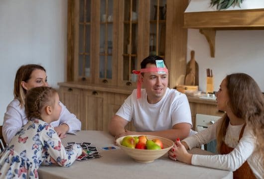 Family playing a game at the kitchen table