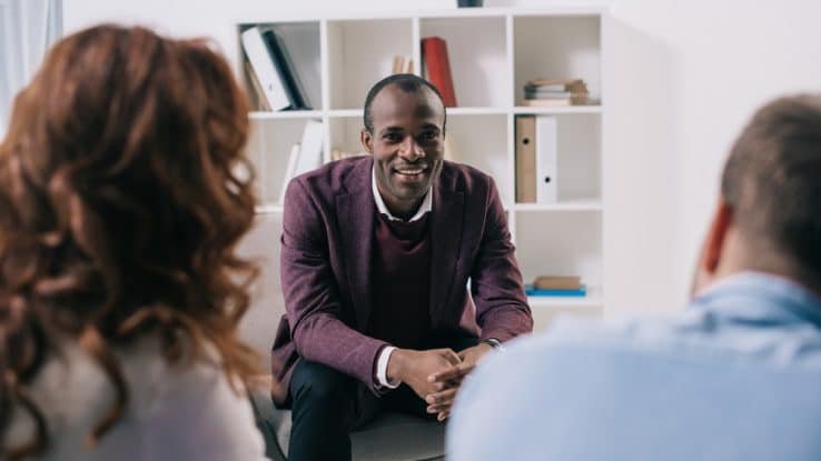 Three people attend a mental health team meeting
