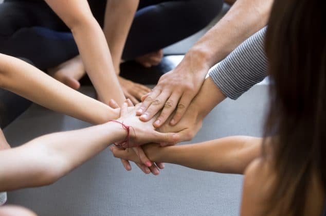 Team with hands together in a show of unity