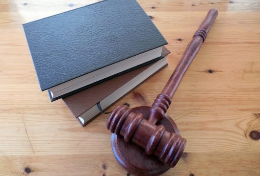 Gavel and legal books resting on table
