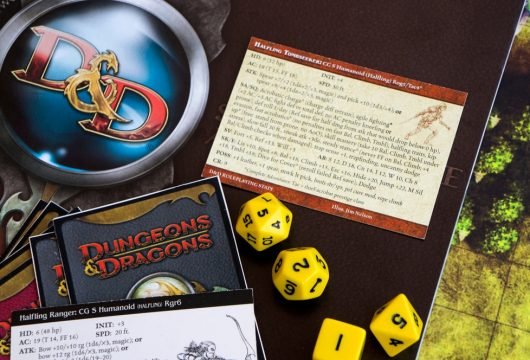 Dungeons and Dragons game pieces and cards resting on a table